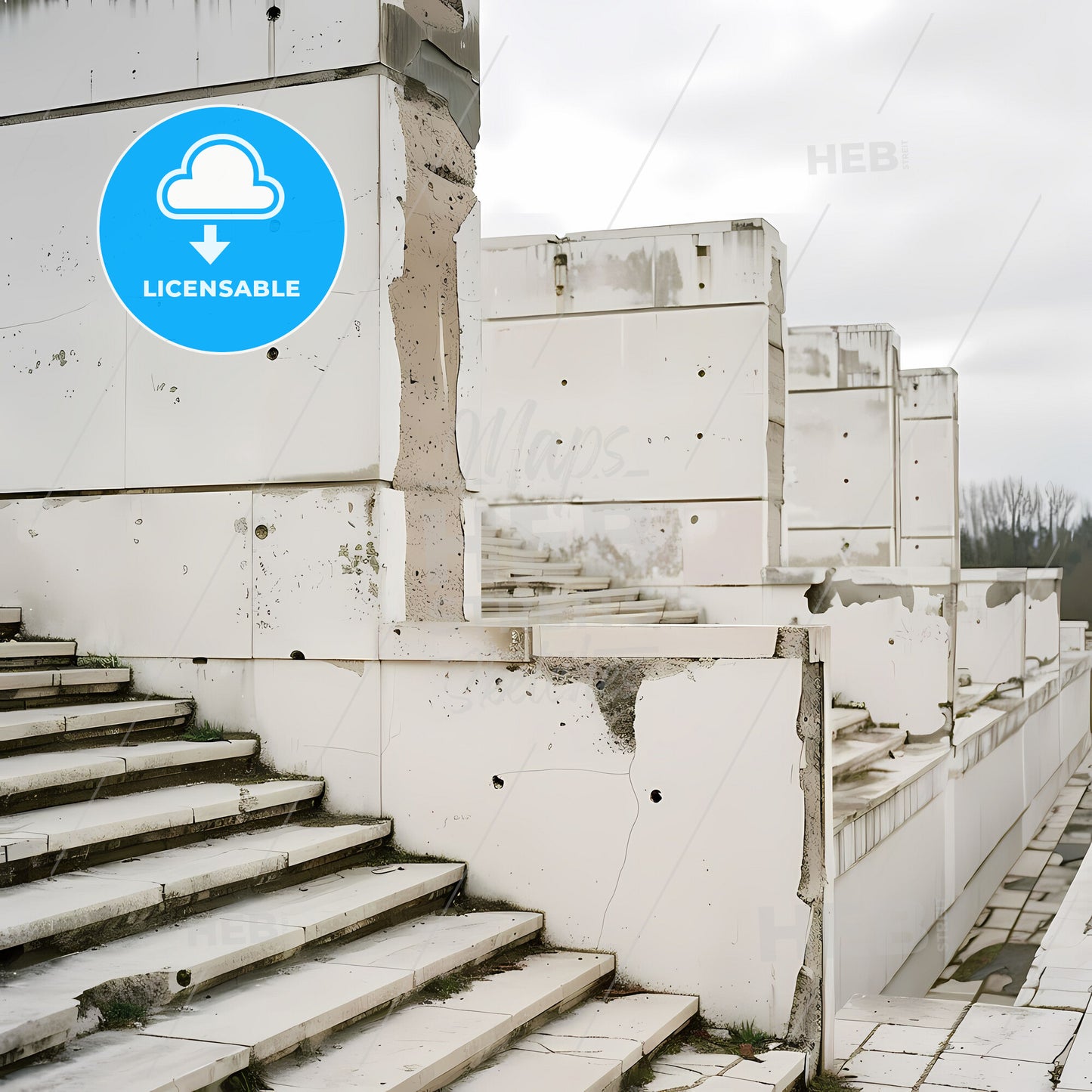 Black and white photo of a white stone staircase with concrete walls and vibrant painting