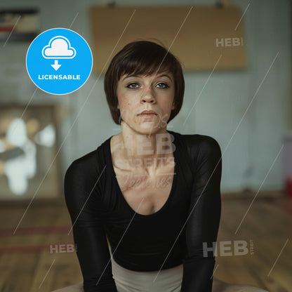 Nadia Comăneci, Born: 1961, Romanian gymnast - A Woman Sitting On The Floor