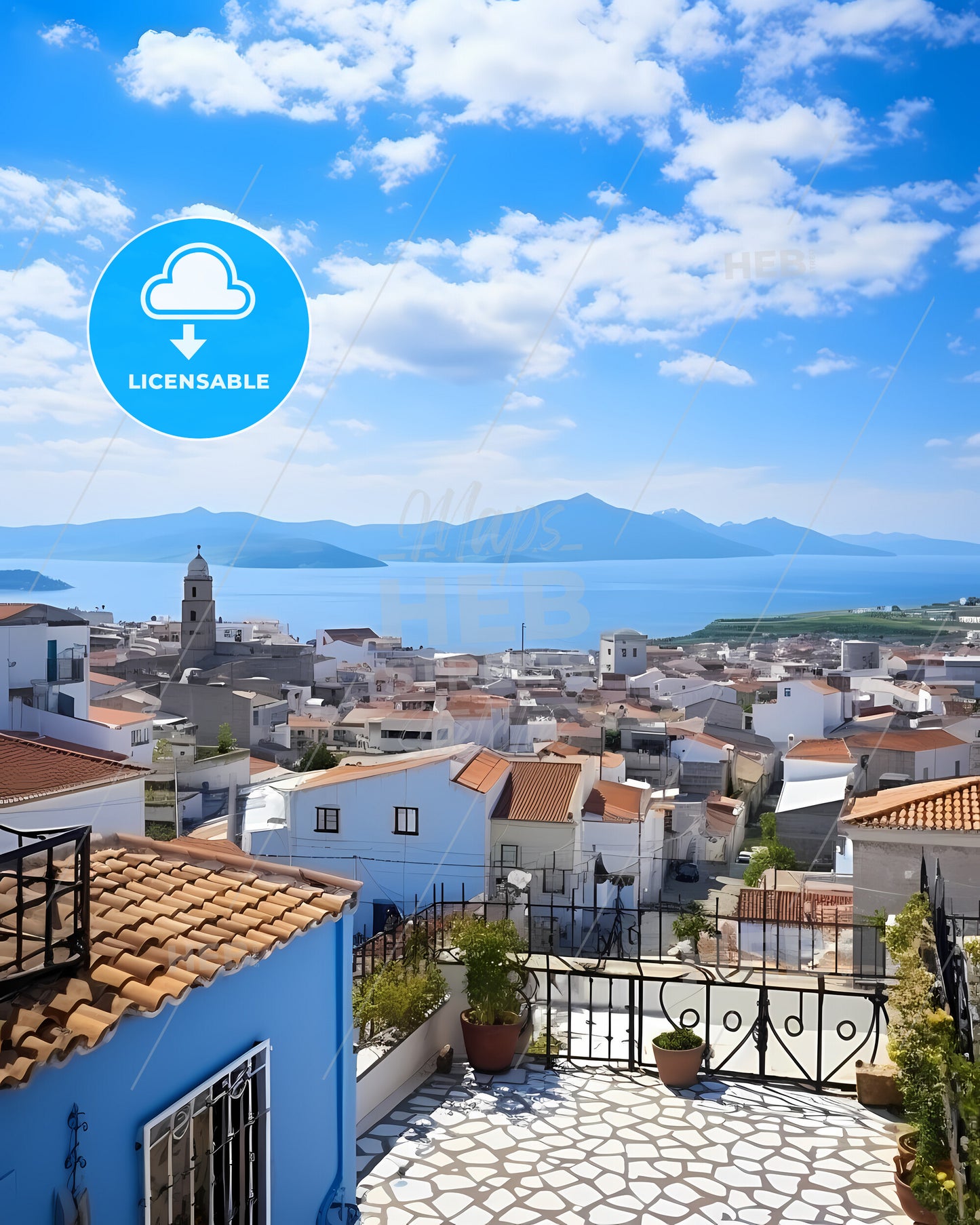 Ponta Delgada, Portugal, a rooftops of a town with a body of water in the background