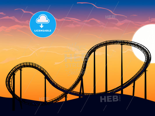 Roller coaster loop silhouetted at sunset