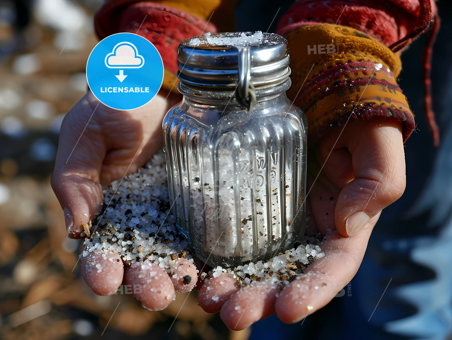 A Salt Shaker On A Counter, A Person Holding A Salt Shaker